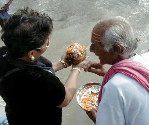 Brahmin pujari performing a puja for Rita on the bank of the Ganges in Haridwar